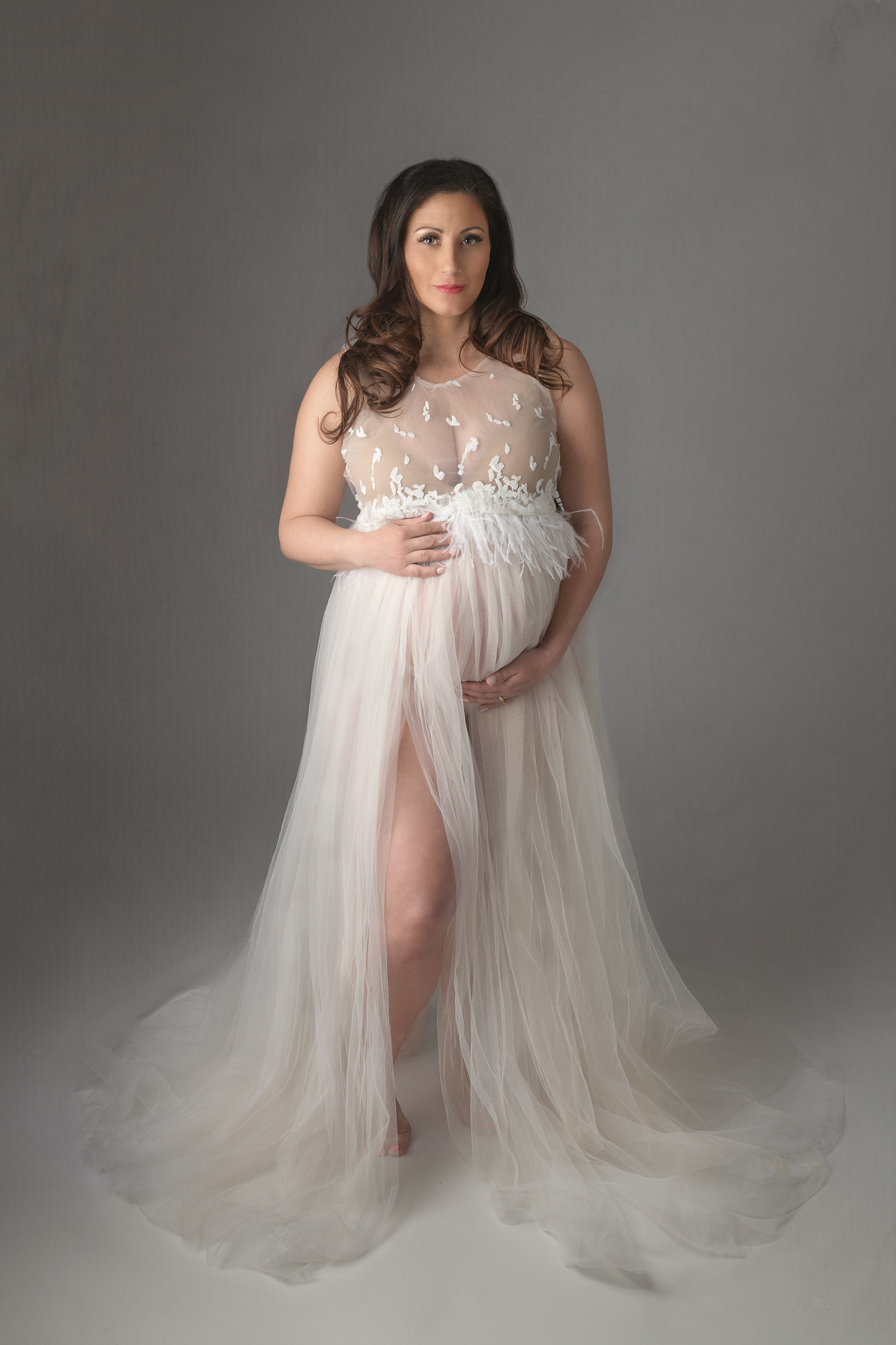 pregnant woman in a sheer maternity gown