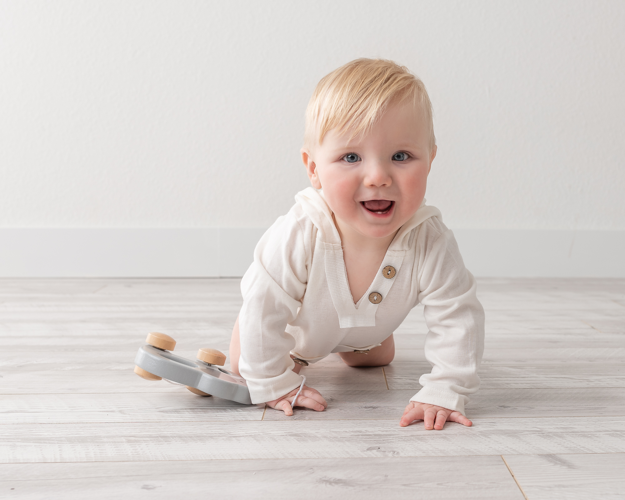 baby crawling on a floor in a studio