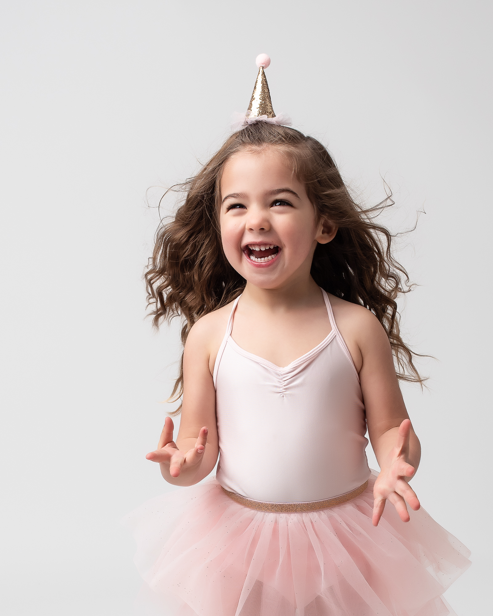 little girl in pink tutu wearing a party hat Stone Soup Bend