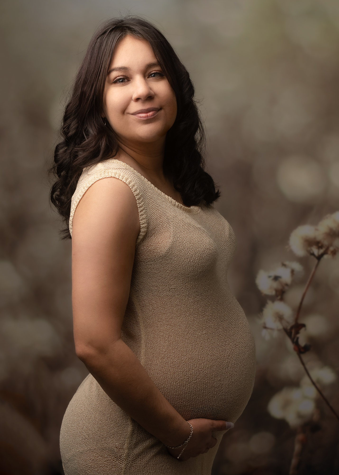 pregnant mom in gold maternity gown with a cotton background Organic Elements Spa Medford