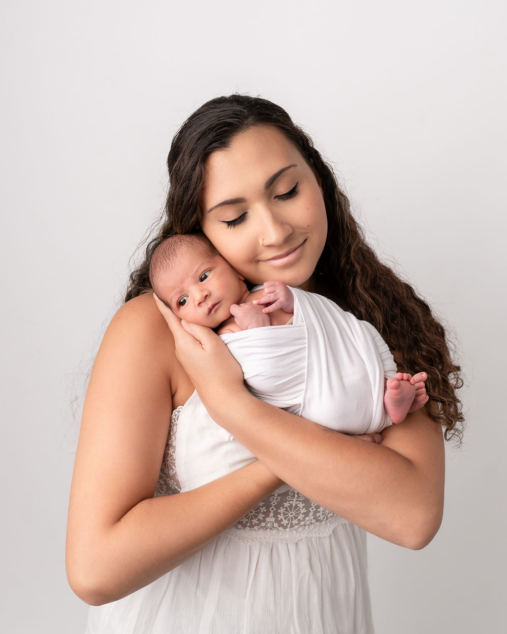 mom in white holding her newborn baby Sanford Clinic Klamath Falls