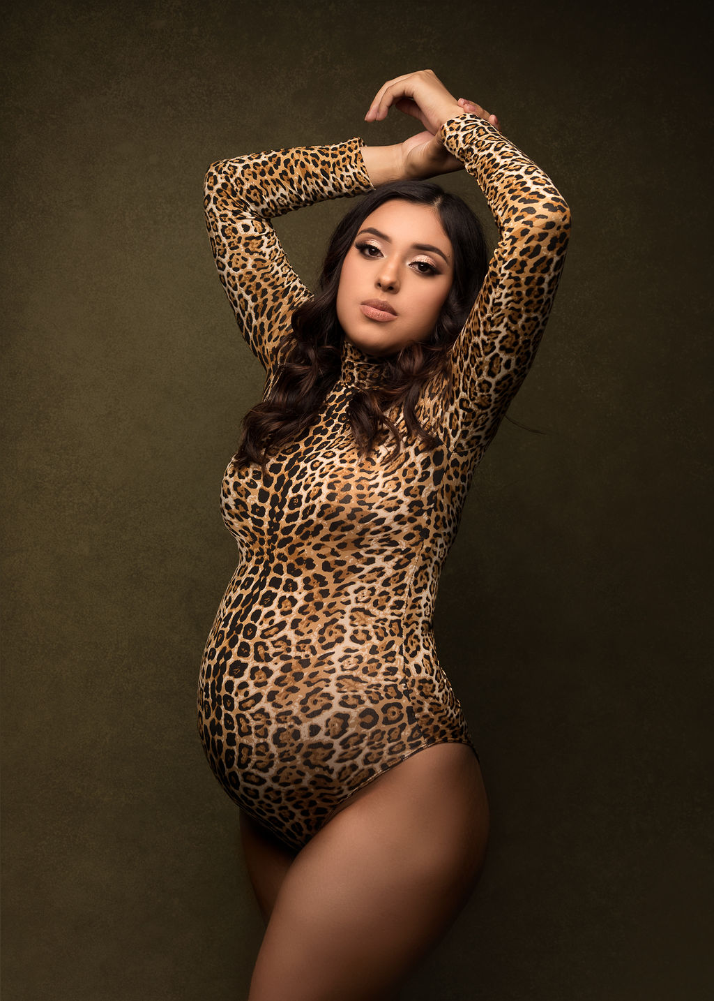 pregnant woman in cheetah print bodysuit with her arms above her head Sky Lakes Women’s Health Clinic