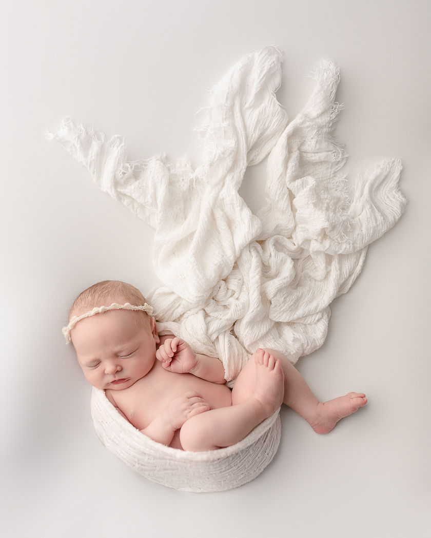 newborn baby wrapped in white cloth sleeping Medford Pediatricians