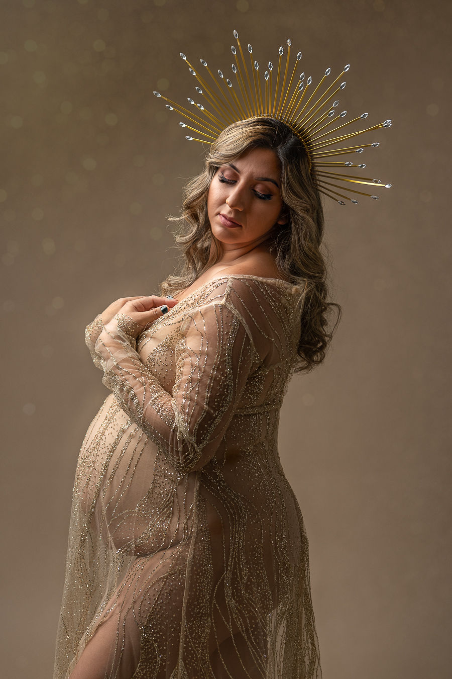 pregnant woman in tan maternity gown and crown Central Oregon OB-GYN