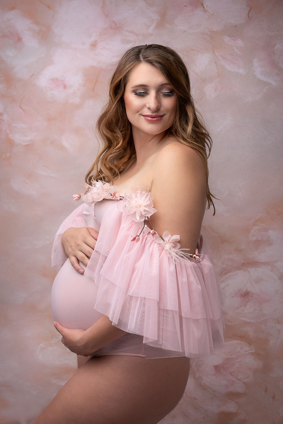 pregnant woman in pink tulle gown