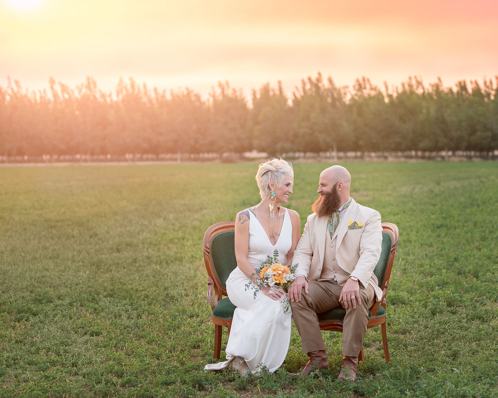 bride and groom sitting on a loveseat in a field Southern Oregon Wedding Venues